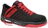 Preview: The shoe is a black sneaker with red accents. It has a flat sole and laces. There are line patterns on the side and the logo is clearly visible. It looks sporty and modern.