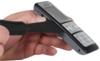 Preview: A hand is holding a black mobile phone. A tool for removing the battery is placed on the other side. The hand and the phone are the focus of the image.