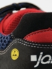 Preview: The image shows a part of a shoe with a combination of black, red, and blue material. There is a yellow ESD symbol and white stitching along the edge.