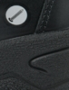 Preview: The image shows a part of a black shoe made from textured material. On the surface, there is a small round symbol featuring a pencil.