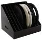 Preview: The image shows a slanted, black storage container with several round, flat plates inside. Two plates are white and several are black. Ideal for organizing.