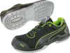 Preview: The image shows a pair of athletic safety shoes. They are primarily black with bright green accents. The sole is slip-resistant and has a rugged tread for better grip.