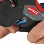 Preview: The image shows a hand holding a cable stripping tool from Knipex. It has a black surface and a red handle. A blue wire is being threaded through the tool.