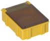 Preview: The image shows a small, square box in bright yellow. It has a transparent lid that is slightly rounded. The sides are smooth with some vertical grooves.