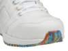 Preview: The image shows the front part of a white sports shoe. The sole features a colorful, abstract pattern in blue, yellow, and red. The laces are white and the surface has small ventilation holes.