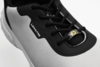 Preview: The image shows a sporty shoe in gray and black. It has a flat sole, laces, and a striking logo. The materials appear lightweight and breathable.