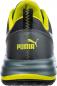 Preview: The image shows the back of a sporty shoe. It is primarily black with yellow accents and features a well-known logo. The sole is thick and provides good grip.