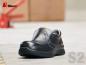 Preview: The image shows a black safety shoe with a closed toe cap and an elastic gusset. The sole is sturdy and slip-resistant, ideal for work environments.