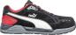 Preview: The shoe is a sporty sneaker in black with red and white accents. It has a flat sole, a padded tongue, and the brand "Puma" is prominently visible.