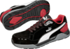 Preview: The image shows a pair of black sports shoes with red accents. They have a white sideline and a textured rubber sole. The laces are also black.