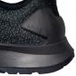 Preview: The image shows a part of a sports shoe with a textured, black upper. The sole is slightly shaped, with a prominent, stabilizing element at the heel.