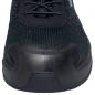 Preview: The image shows the front view of a sports shoe. The shoe is predominantly black with a textured upper and a sturdy, rounded sole. The laces are visible.