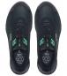 Preview: The image shows a pair of black sports shoes with a green accent. They have a modern, simple shape and flat laces. The sole is slightly curved and made from a durable material.