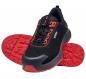 Preview: A black shoe with red accents. The laces are red, the sole has a distinctive non-slip design in red. The shoe has a sporty shape.