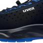 Preview: The image shows a black sports or casual shoe with blue accents. The shoe has a modern, breathable surface with small holes and a flexible sole.