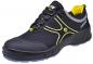 Preview: The shoe is a sporty sneaker in black with yellow and gray accents. It features a lightweight, functional design and a sturdy rubber sole for good grip.