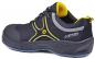 Preview: The shoe is a sporty safety shoe in black with yellow and gray accents. It features a sturdy sole and breathable material, ideal for both work and leisure.