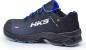 Preview: The shoe is a sporty sneaker in black with blue accents. It has a sturdy sole and the "HKS" logo on the side. The shoelaces are also blue.