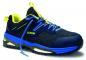 Preview: The shoe is sporty, dark blue with yellow and blue accents. It has a strong sole, a padded interior, and a grippy surface. The laces are long and blue.