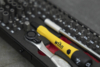 Preview: The image shows a toolbox with various screwdrivers and a ratchet tool. Some bits are arranged in a black-red holder. A yellow handle is clearly visible.