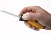 Preview: The image shows a hand holding a screwdriver with a yellow-black handle. The metal tip is long and narrow, suitable for driving screws.