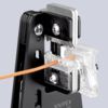 Preview: The image shows a tool for stripping cables. It has a black, solid structure with sharp, metallic blades and an orange cable being fed through the tool.