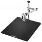 Preview: The image shows a black work surface with a metal bracket. The bracket is adjustable and has a clamp to secure objects.