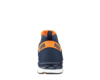 Preview: The image shows the rear view of a dark blue sports shoe with orange accents. At the top edge, the brand logo "PUMA" is displayed. The sole is designed to be grippy and robust.