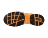 Preview: The underside of a sports shoe with a non-slip rubber sole. It features a black pattern with diagonal and rectangular tread and orange accents.