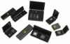 Preview: The image shows several black caskets that are open. Inside them are small electronic components, possibly computer chips or memory modules. Some caskets feature a warning symbol.