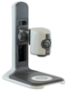 Preview: The image shows a camera on a stable, gray stand. The camera has a rectangular shape, a lens, and numerous buttons for operation. It is designed for visual support.