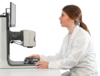 Preview: A woman in a white lab coat is sitting at a table. In front of her, there is a screen and a microscope. She is holding a circuit board in her hand and looks focused.