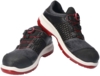 Preview: The image shows a pair of athletic shoes in black and gray with red accents. They feature a textured surface, a lightweight sole, and a quick lacing system with a twist lock.