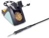 Preview: The image shows a soldering iron stand with a golden-colored solder and a black soldering iron that has a thin, pointed tip. The stand has a practical shape and several storage options.