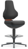 Preview: The chair has a high, ergonomic backrest and a wide seat. It stands on a stable, round base with five legs and a footrest. The surface is black with an orange accent.