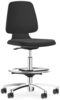 Preview: The chair is height-adjustable, has a black seat and backrest. It stands on five casters and has a round metal footrest that provides stability.