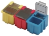 Preview: The image shows three small, colorful containers. From left to right, they are yellow, red, and blue. The yellow and red containers have a flat lid, while the blue one is open and reveals an open compartment.