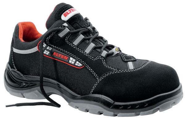 The shoe is a black safety sneaker with gray and red accents. It features a reinforced toe cap, breathable material, and a non-slip sole. Laces are included.