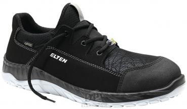 The shoe is a modern, black sneaker with a sporty shape. It has a synthetic upper, laces, and a bright, textured sole. The 