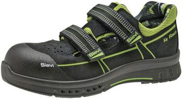 The shoe is a black half-shoe with two wide Velcro straps and green accents. It features a sturdy, non-slip sole and breathable upper material. Ideal for work safety.