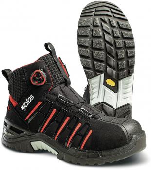 The image shows a black, sturdy work shoe with red accents. It features a high upper, a slip-resistant sole, and reinforced toes. The top is textured and provides good grip.