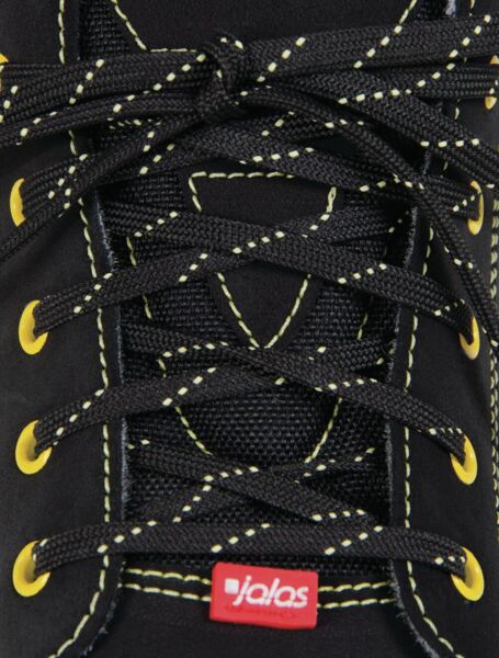 The image shows the laces of a black shoe. The laces are black with yellow accents, and a small red label is visible on the shoe.