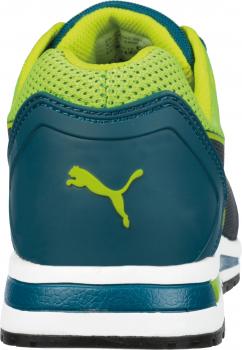 The image shows the back of a sports shoe. It is primarily in dark blue and green, features a breezy mesh element, and has a white sole edge. A Puma logo is displayed on the back.