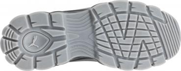 The image shows the underside of a sports shoe. The sole is gray with various tread patterns, including waves and grooves, as well as a stylized logo in the center.