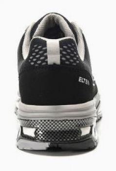 The image shows the rear view of a black sports shoe. The shoe has gray details, a breathable material, and a striking, textured sole. A logo is visible.