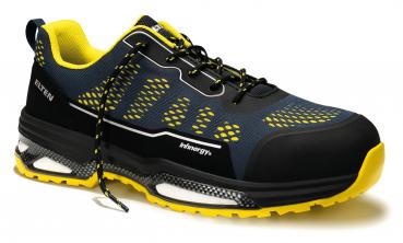 The shoe is sporty, with a black surface and yellow accents. It has a padded sole, reinforced toes, and a breathable upper with a pattern.