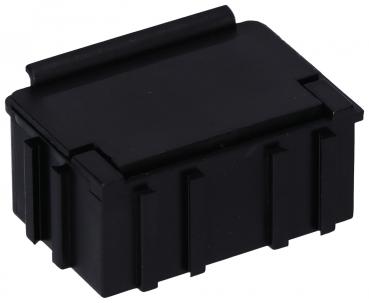 The image shows a small, black rectangular box with a slightly angled flap. The top is smooth, while the sides are structured with vertical grooves.