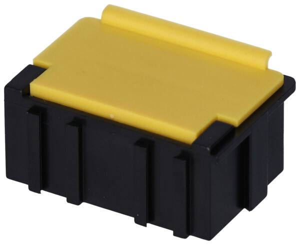 The image shows a small, rectangular box with a yellow top and a black bottom. The box features implied grooves on the sides and a slightly rounded shape on top.