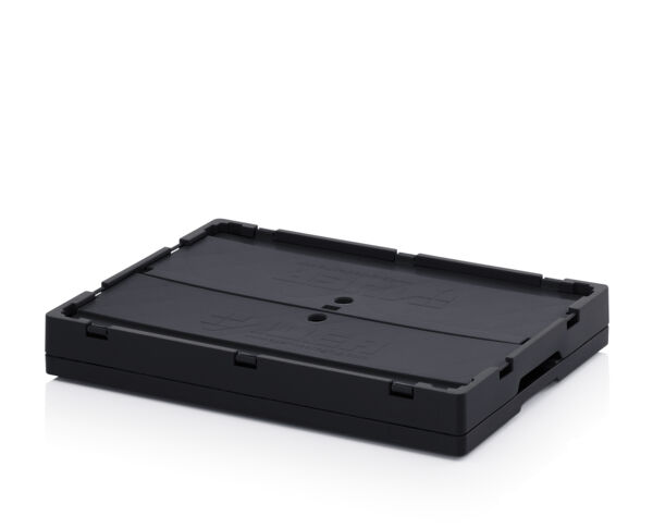 The image shows a rectangular, flat box made of black plastic. It has a smooth surface with slight patterned textures and rounded corners. There are two small holes in the center.