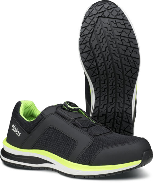 The image shows a pair of black sports shoes with bright green accents. The shoes have a non-slip sole with a textured pattern and a quick lacing system.